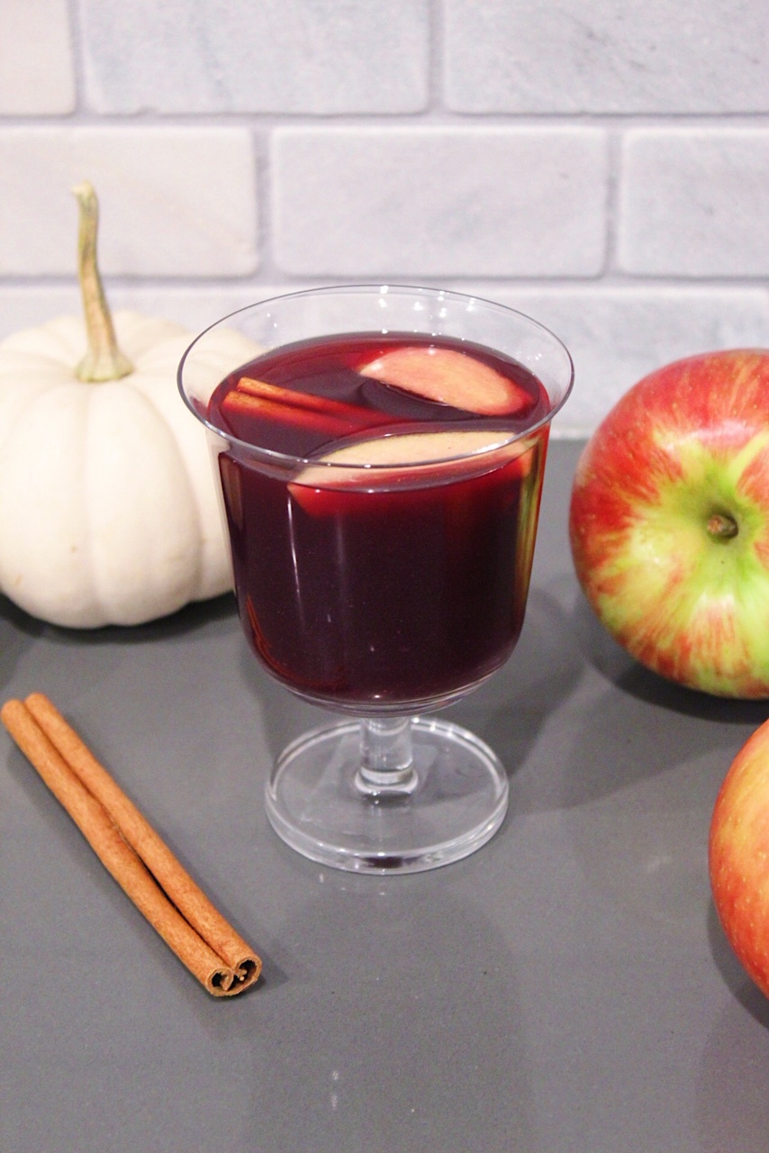 Red Wine Sangria in a glass with apple slices.