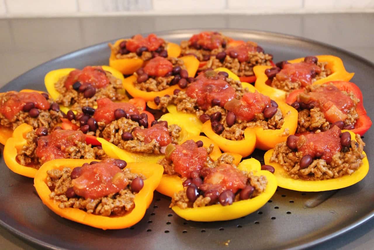 Pepper nachos on a sheet pan topped with salsa.