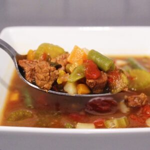 Close up picture of a spoonful of Homemade Vegetable Beef Soup