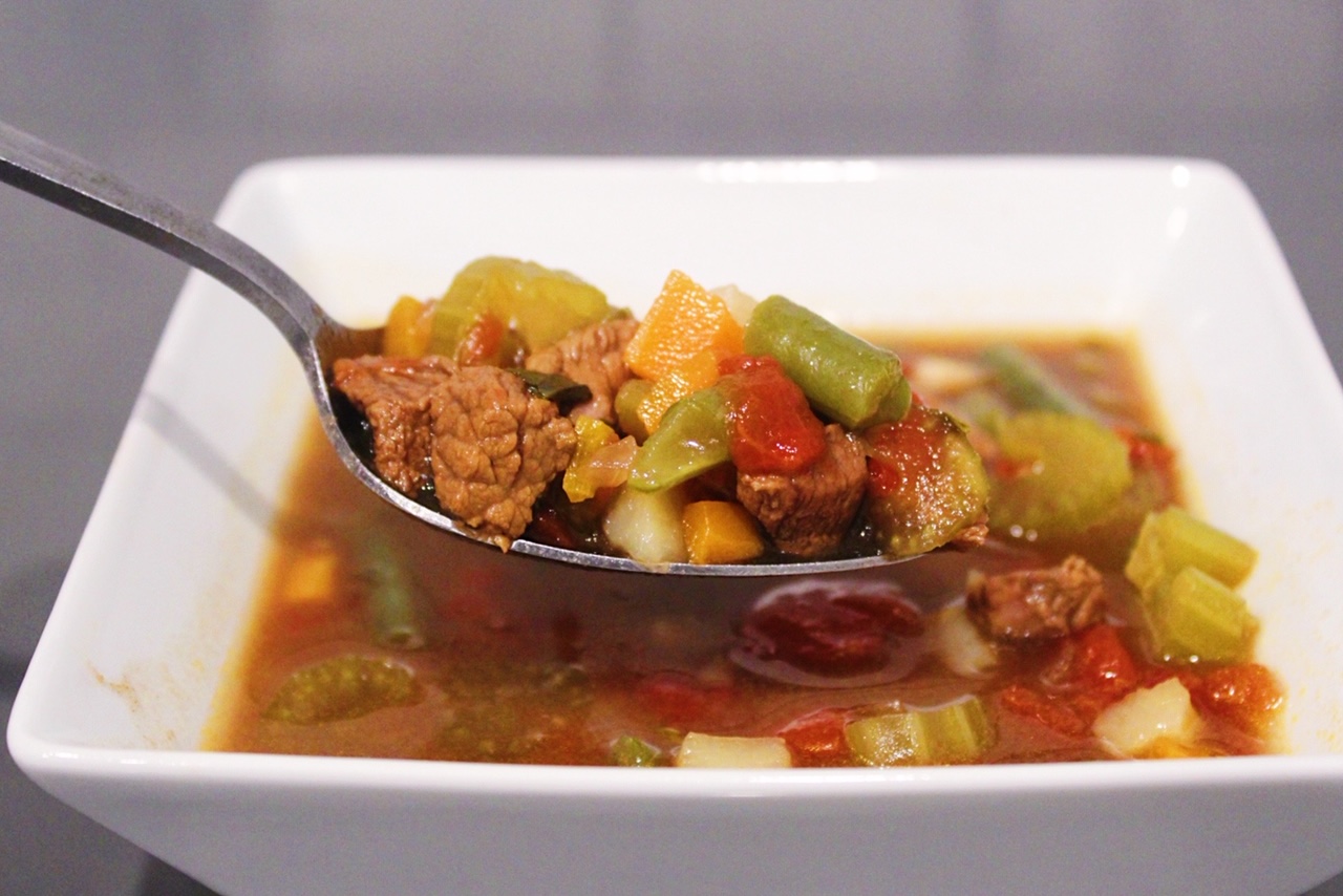 Homemade Vegetable Beef Soup in a white bowl.