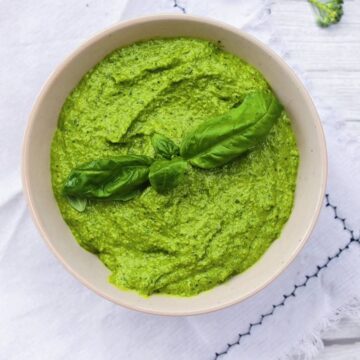 Broccoli Pesto in a bowl on a disk towel.