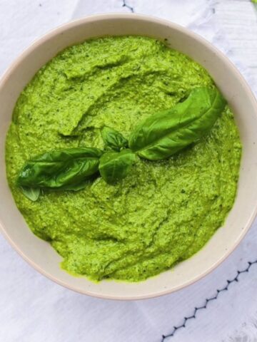 Broccoli pesto in a tan bowl.