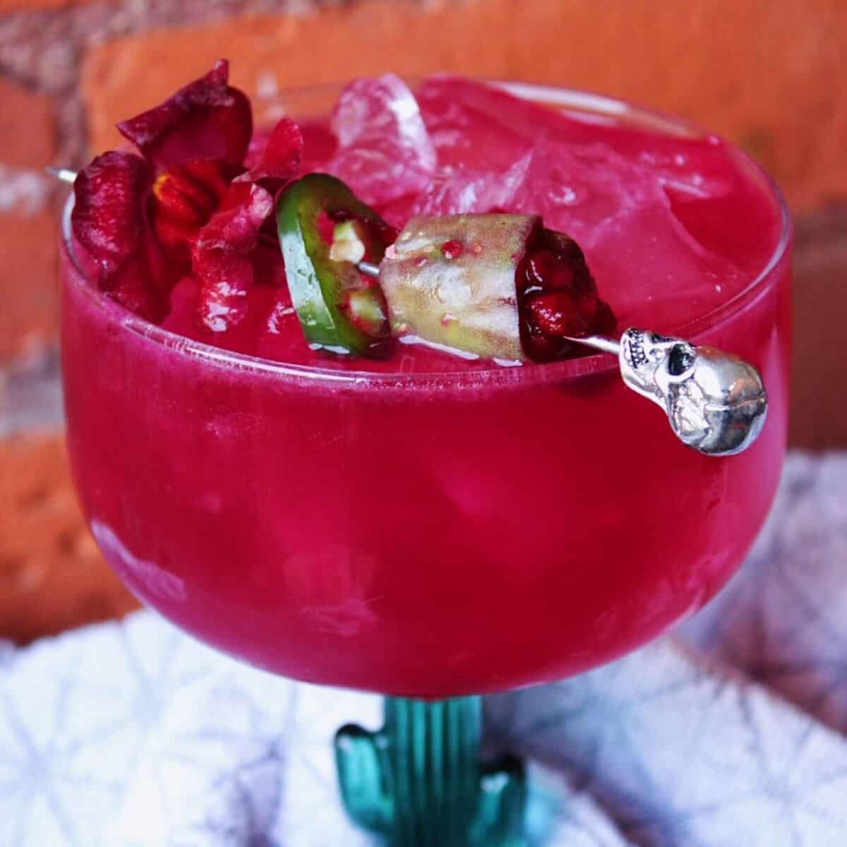 Spicy prickly pear margarita in a cactus glass.