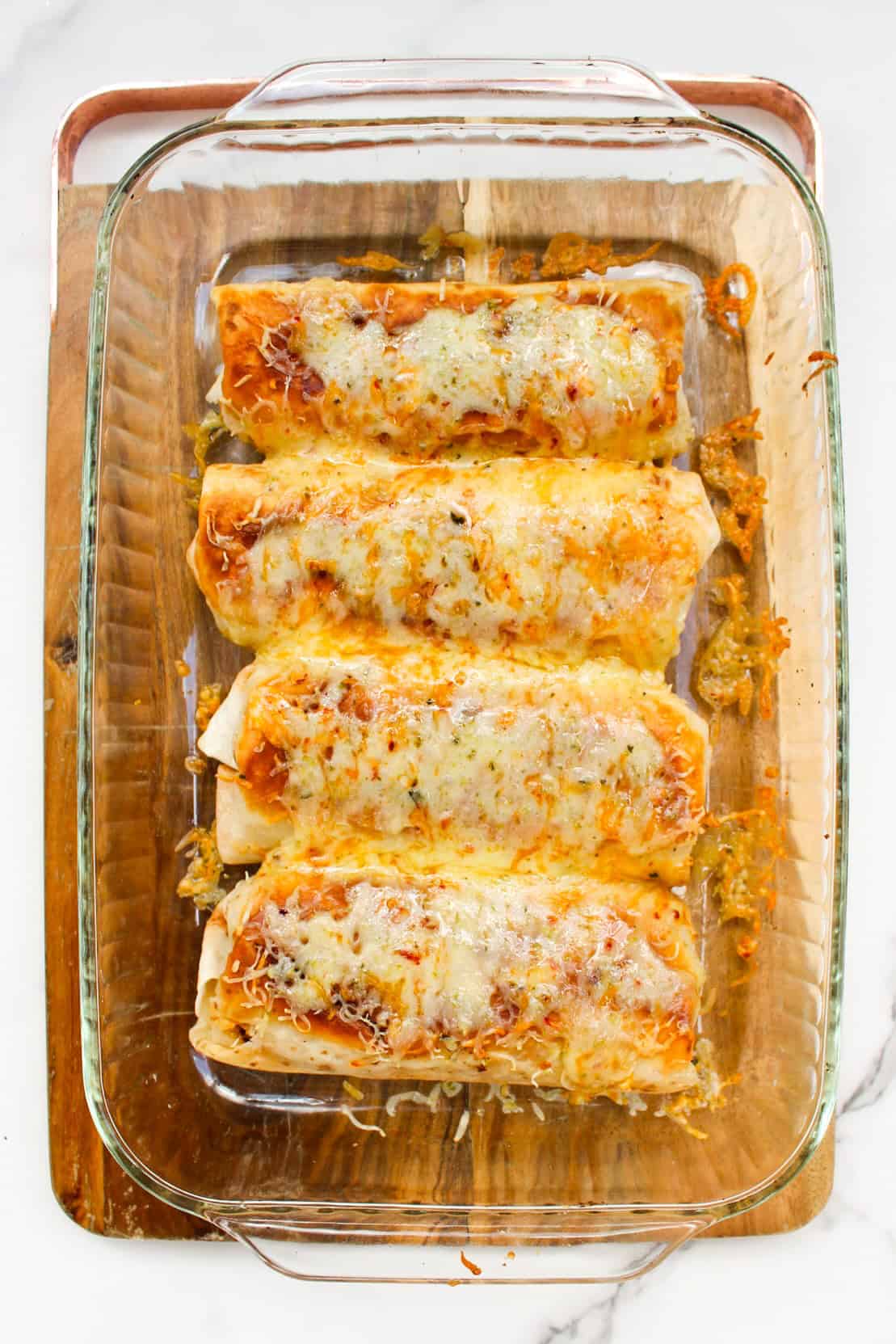 Chimichangas with melted cheese fresh out of the oven.