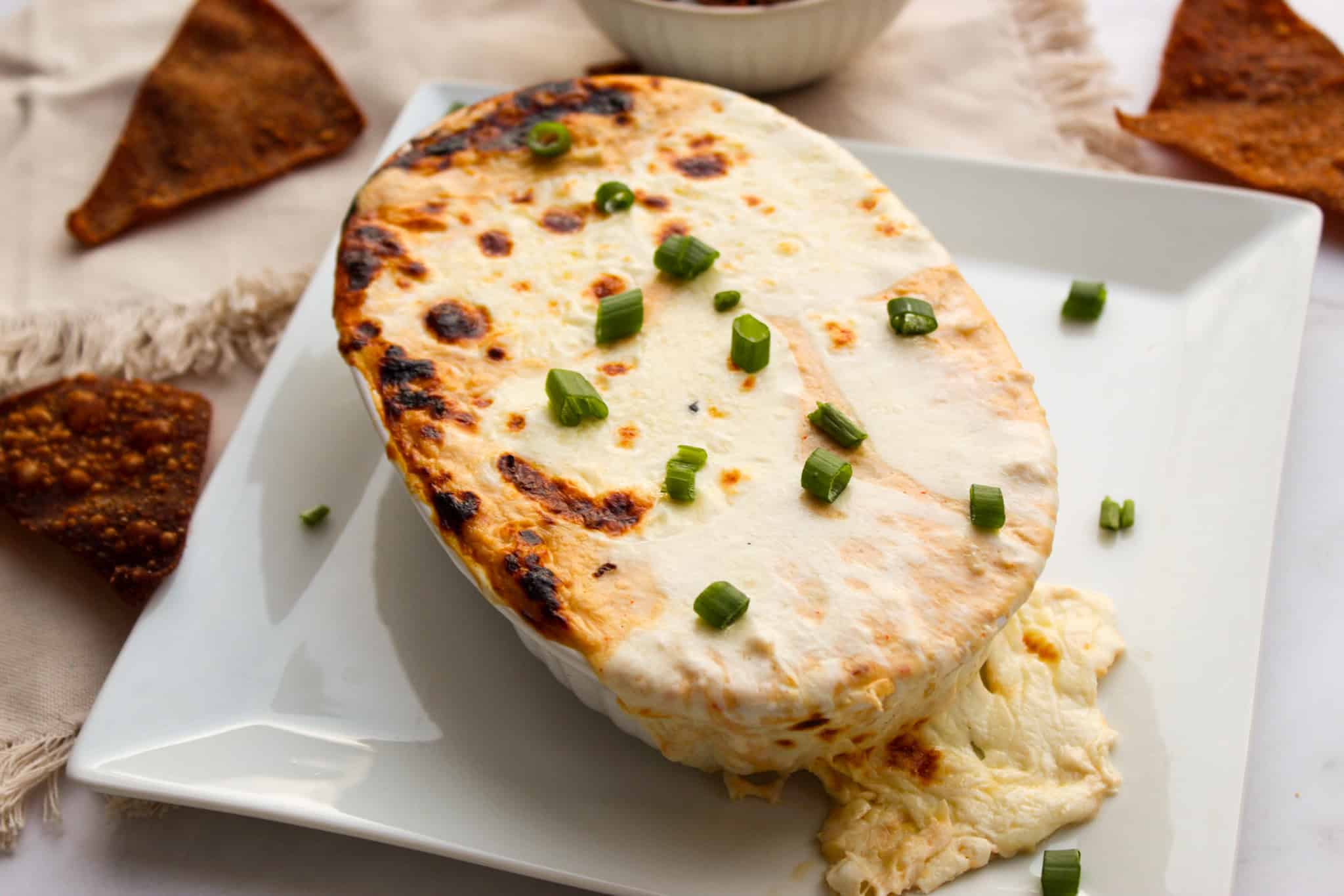 Melted mozzarella cheese overfilling out of baking dish. 